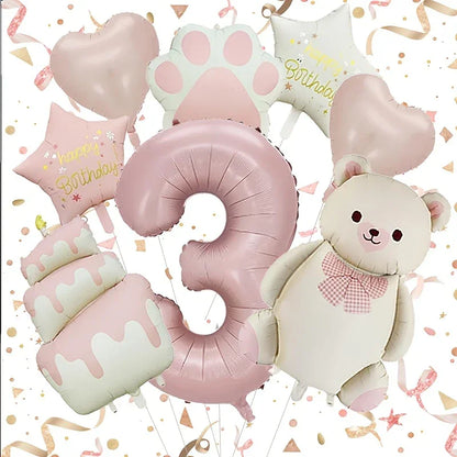 Pink and white birthday party balloons including number 3, bear, cake, hearts, stars, and paw print