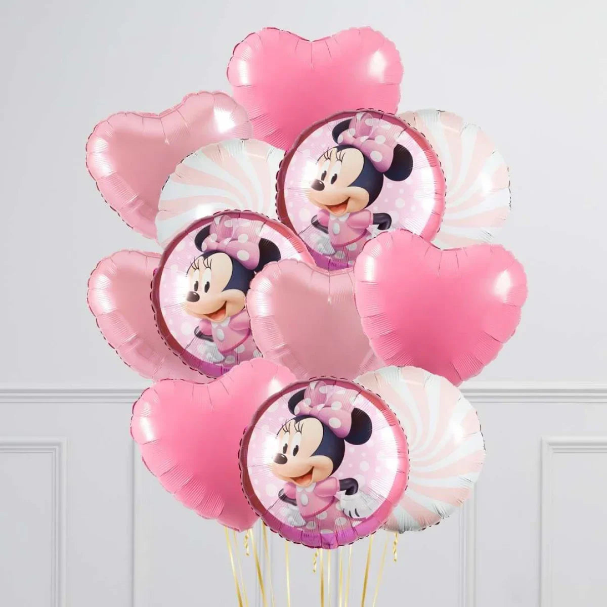 Pink Minnie Mouse foil balloons with heart shapes and swirl pattern balloons in a bunch