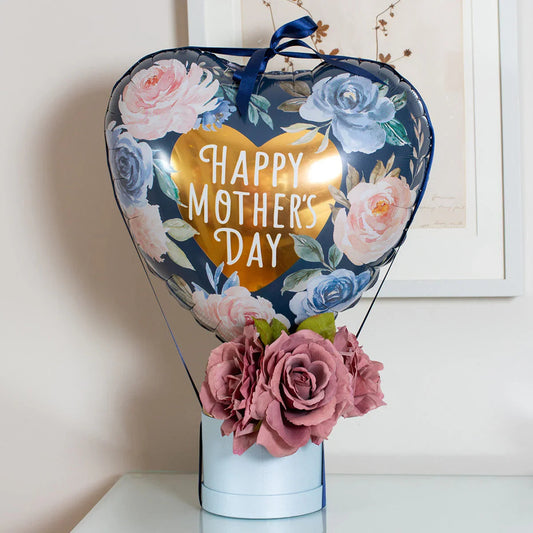 Heart-shaped Mother's Day balloon with floral design and pink roses in a light blue vase