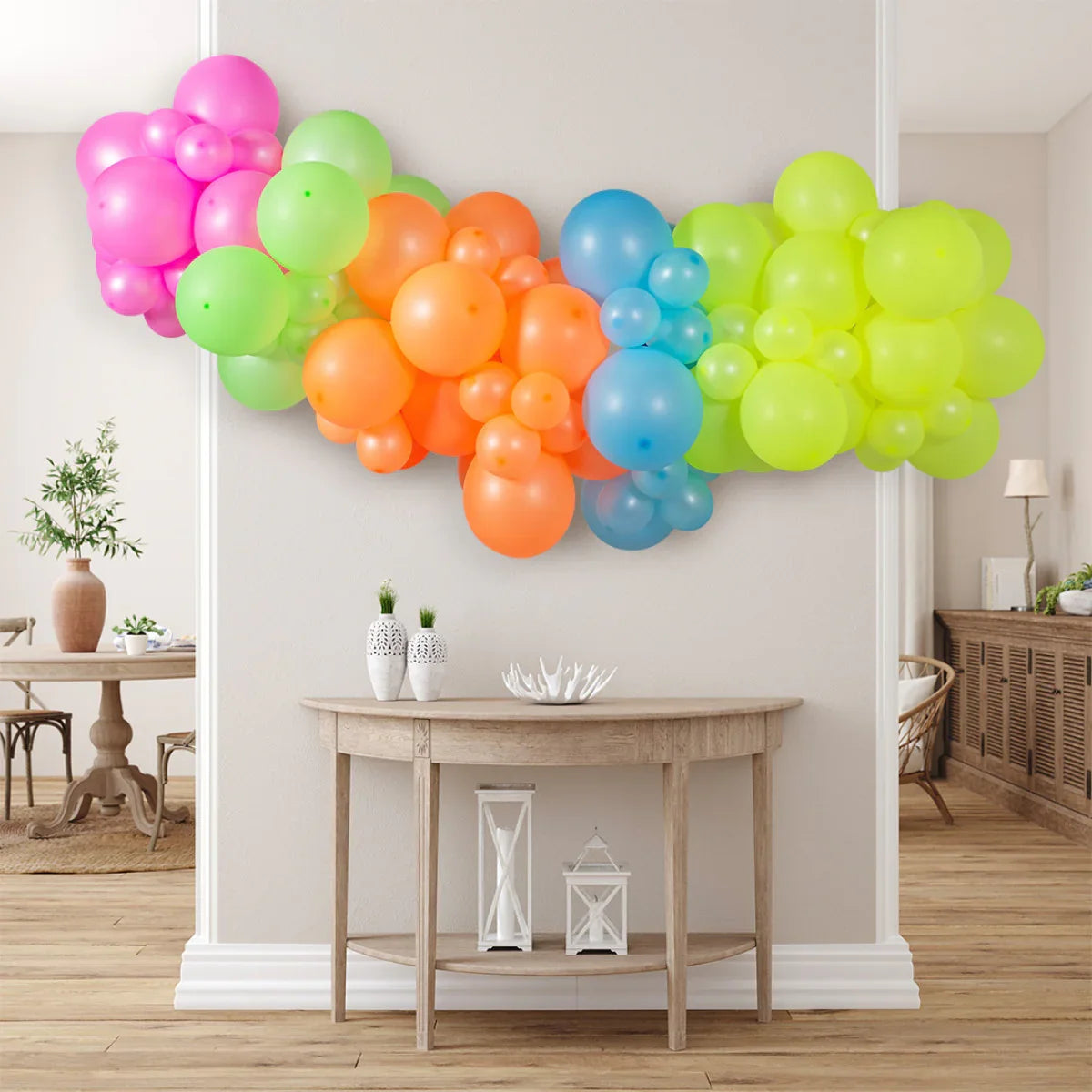 Colorful neon balloon garland in pink, green, orange, blue, and yellow decorating a modern living space