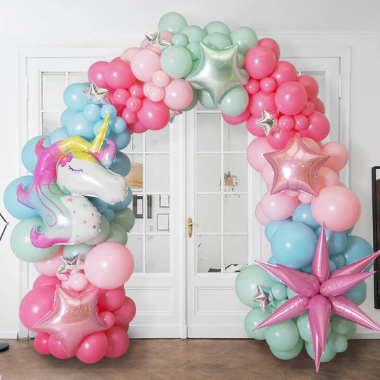 Colorful unicorn-themed balloon arch with pastel pink, blue, green balloons and metallic star accents