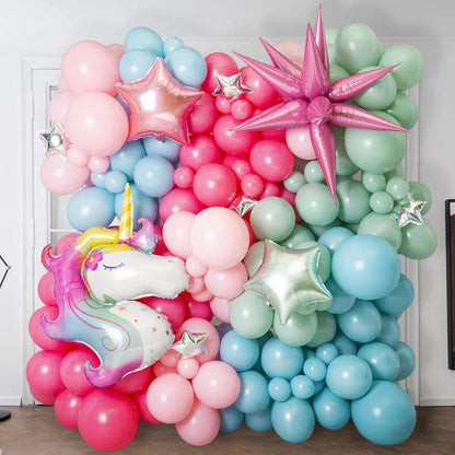 Colorful pastel balloon wall with unicorn balloon and star-shaped balloons for party decoration