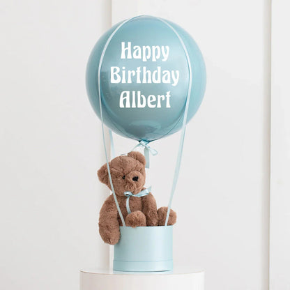 Personalized blue hot air balloon decoration with plush teddy bear and Happy Birthday Albert text
