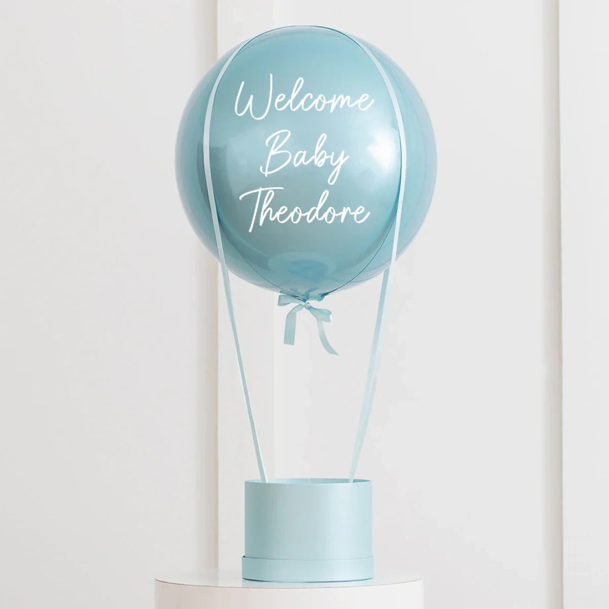 Personalized baby blue hot air balloon decoration with Welcome Baby Theodore text