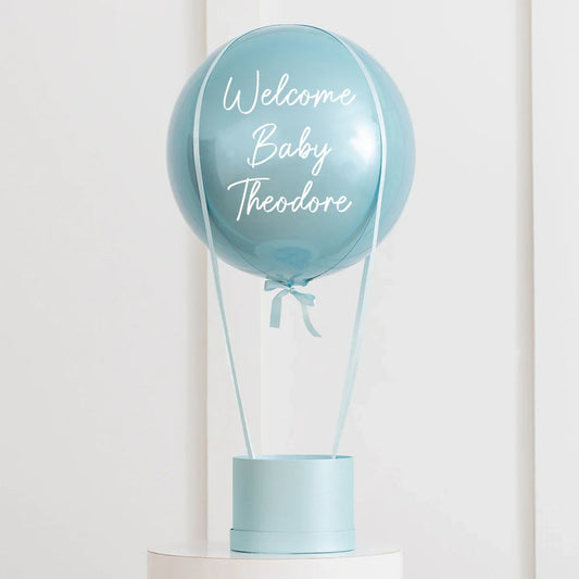 Personalized baby blue hot air balloon decoration with Welcome Baby Theodore text