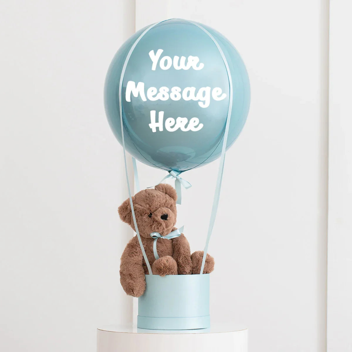 Personalised baby blue orb hot air balloon gift with teddy bear in basket on white background