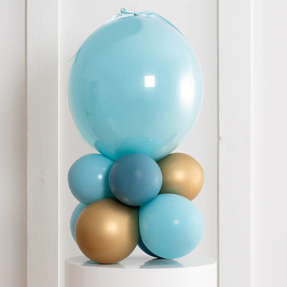 personalized coastal mist blue and gold air-filled balloon stack on white pedestal