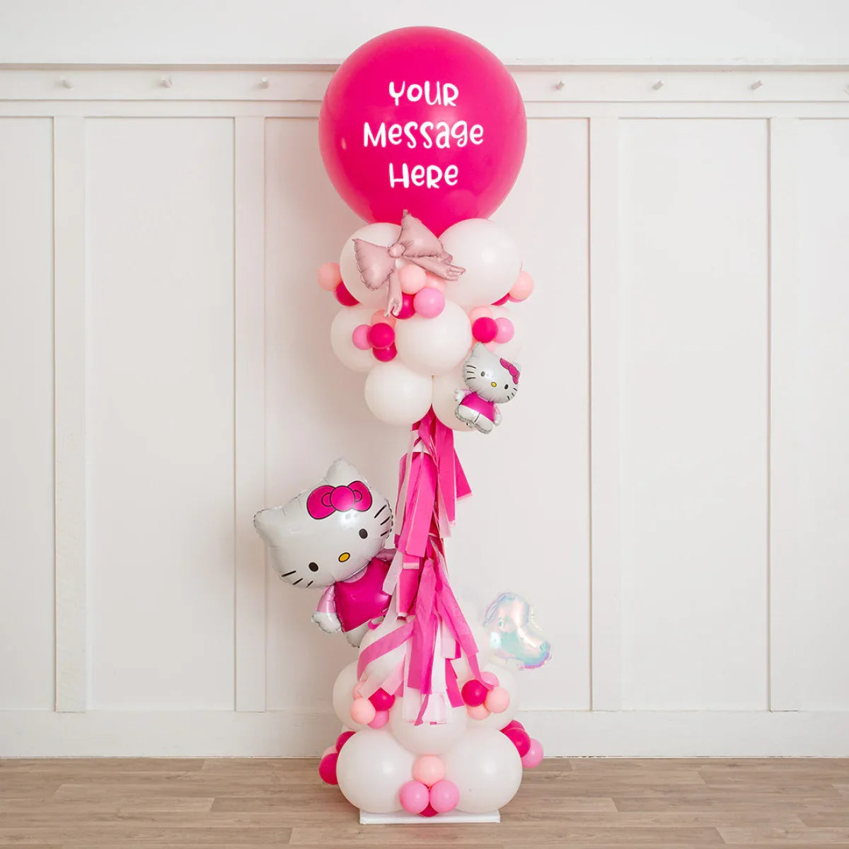 Hello Kitty themed balloon pillar with pink and white balloons and customizable top balloon