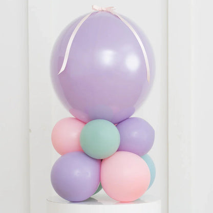 Pastel purple, pink, and teal balloon stack with large lavender air-filled bubble balloon on top