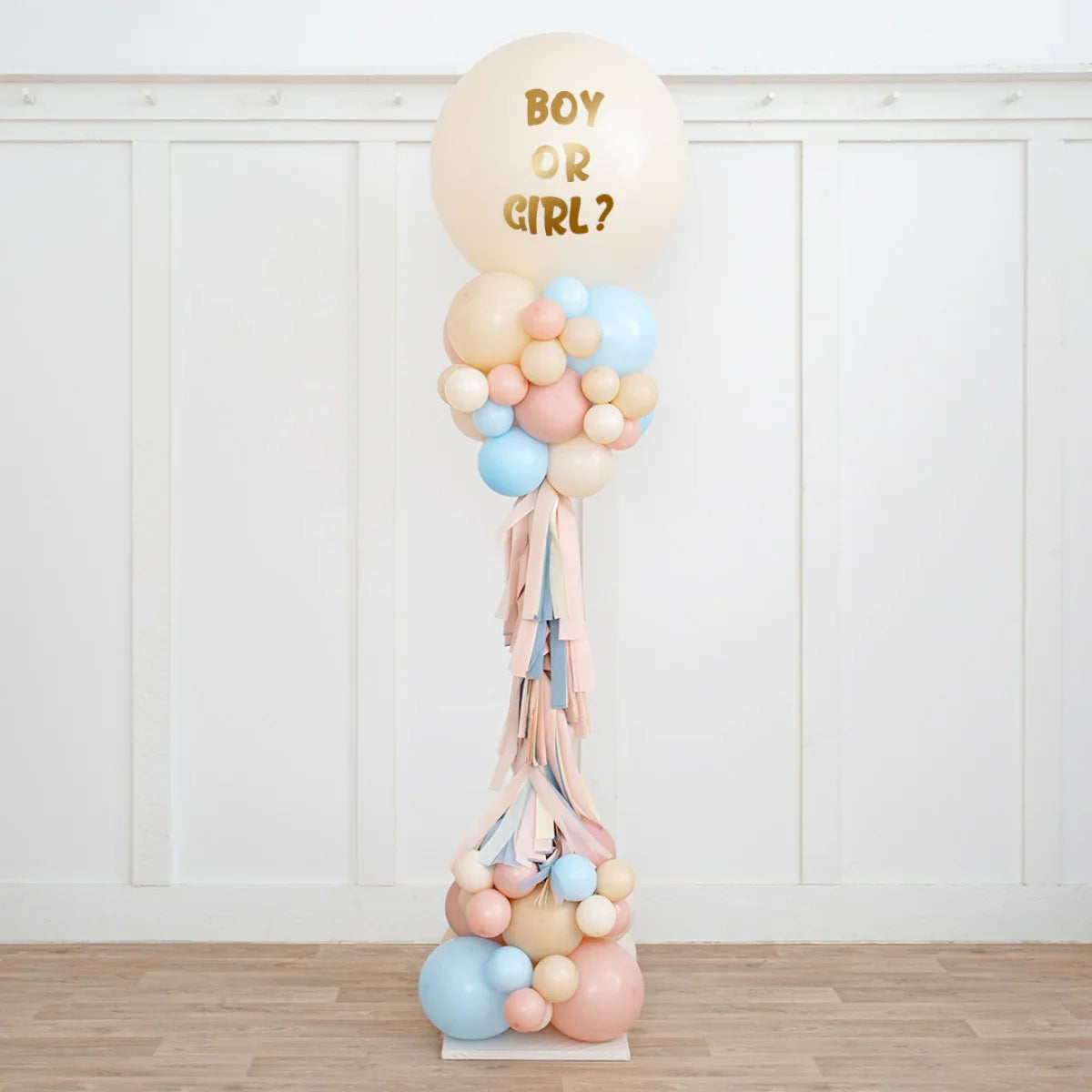 Neutral pink and blue balloon pillar with "Boy or Girl?" text for gender reveal party