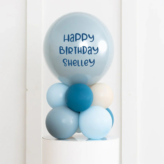 Personalised blue birthday bubble balloon stack with "Happy Birthday Shelley" text