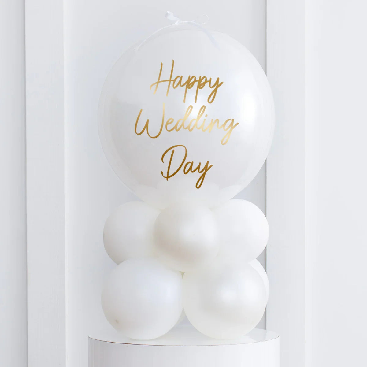 Pearl white air-filled wedding balloon stack with gold Happy Wedding Day text on white background