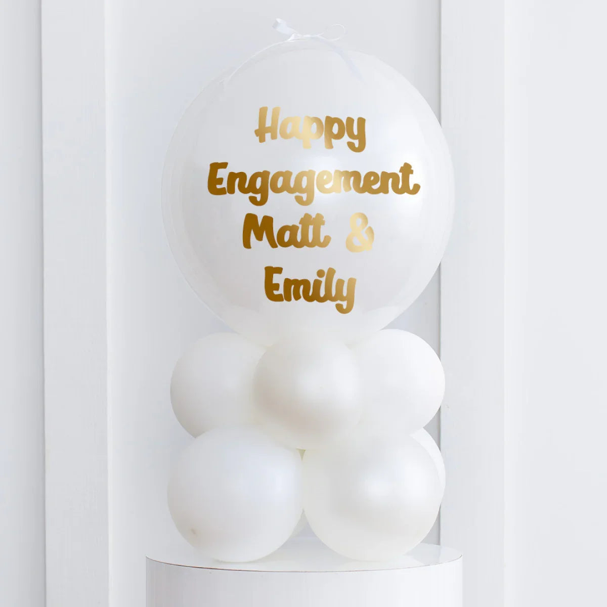 White air-filled bubble balloon stack with gold text Happy Engagement Matt & Emily