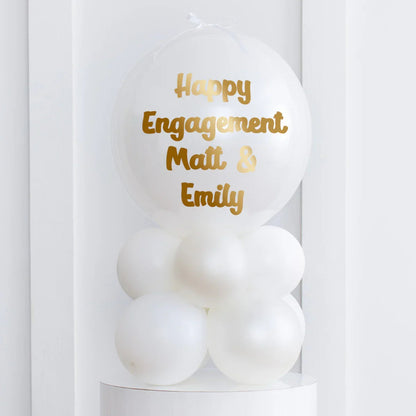White air-filled bubble balloon stack with gold text Happy Engagement Matt & Emily