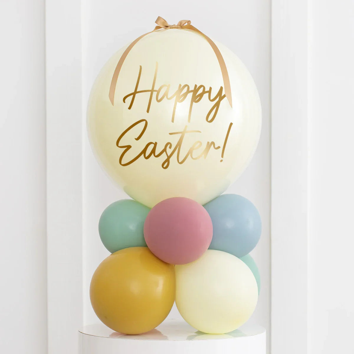 Pastel Easter balloon arrangement with large cream bubble and gold Happy Easter text