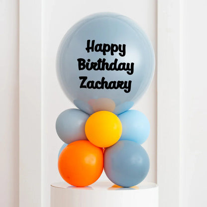 Personalized blue and orange balloon arrangement with Happy Birthday Zachary message