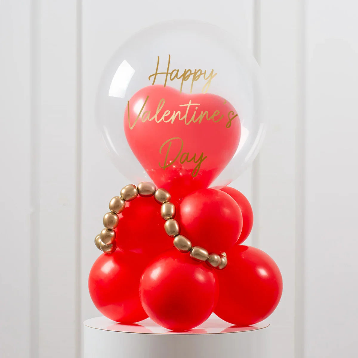 Valentine's Day balloon arrangement with red heart and round balloons inside a clear bubble balloon
