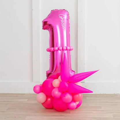 Personalized neon pink number 1 balloon stack with name Gracie and pink balloon cluster