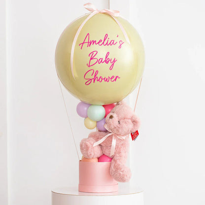Personalized pastel hot air balloon baby shower decoration with pink teddy bear and pastel balloons
