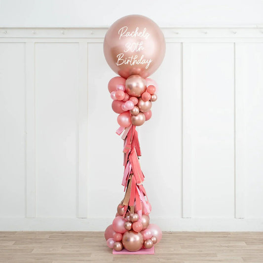 Personalized rose gold and blush balloon pillar with tassels for Rachel's 30th birthday party
