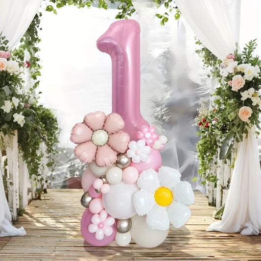 Pink number 1 balloon decoration surrounded by pastel floral and round balloons in garden setting