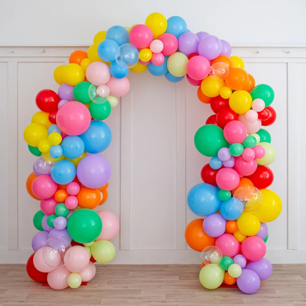 Colorful rainbow balloon arch with various sizes for party decoration indoors