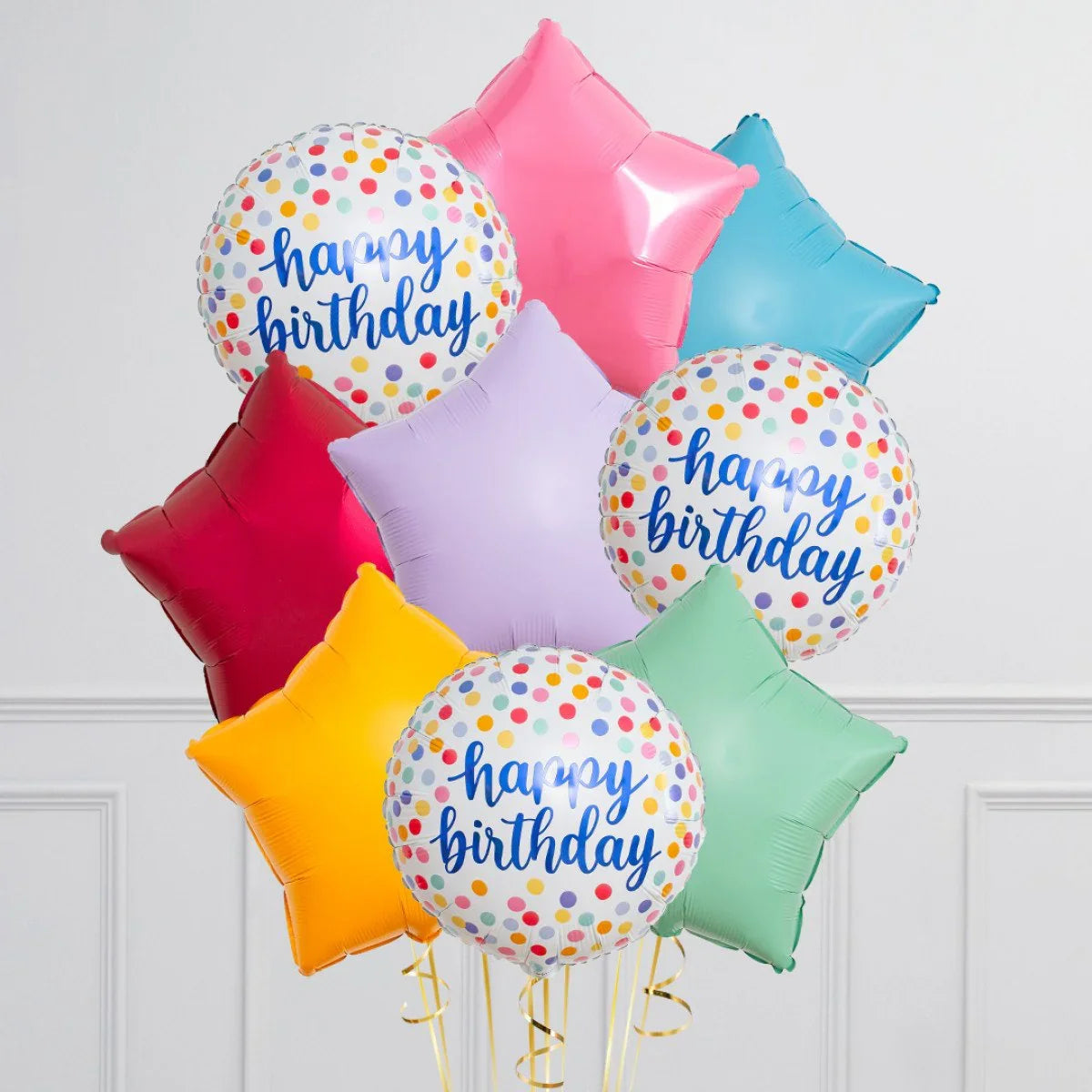 Colorful helium balloons including star-shaped ones and round confetti balloons with happy birthday text