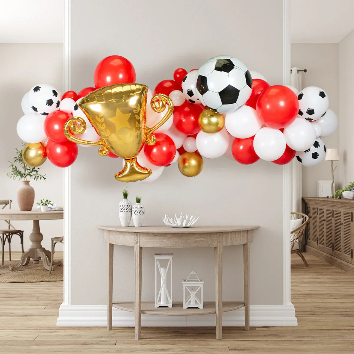 Red, white, and gold soccer-themed balloon garland with gold trophy and soccer ball balloons