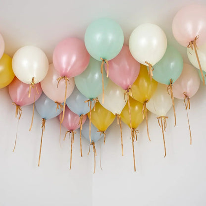 Helium pastel balloons in retro colors floating and tied to ceiling, party decoration