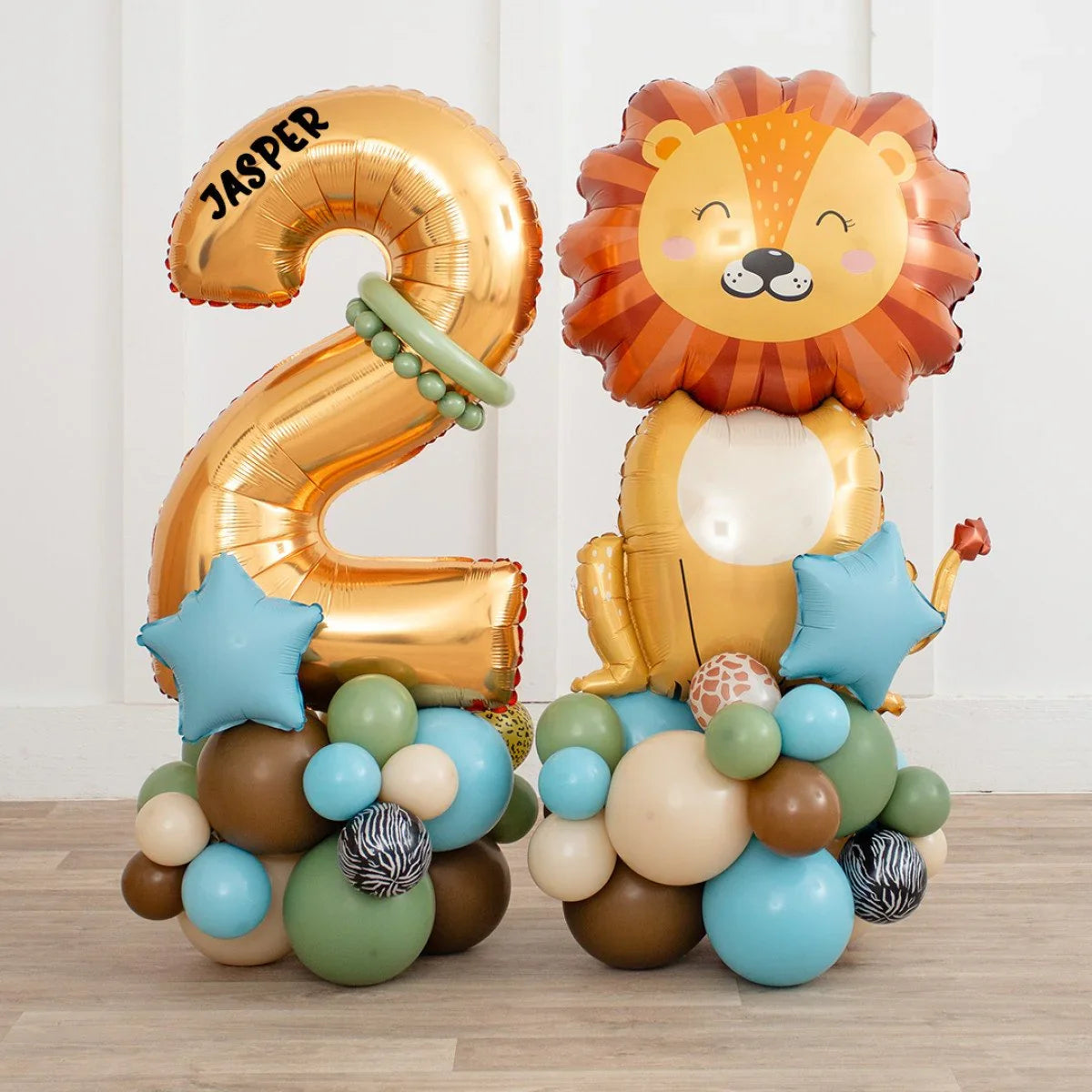 Gold foil number 2 balloon with name Jasper and lion-shaped balloon on blue, brown, green party balloon base