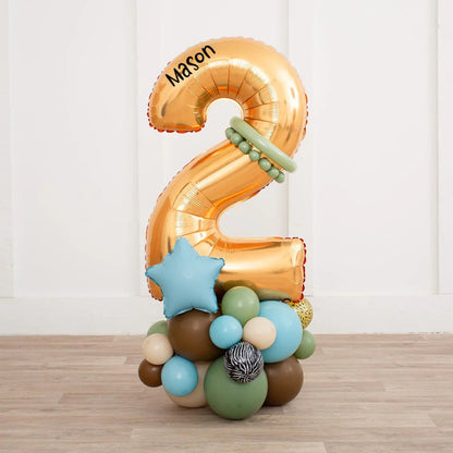 Gold foil number 2 balloon with name Mason, decorated with blue star and earthy tone balloons on wooden floor