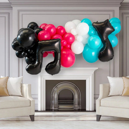 Colorful balloon garland with black musical note balloons above a white fireplace in elegant living room