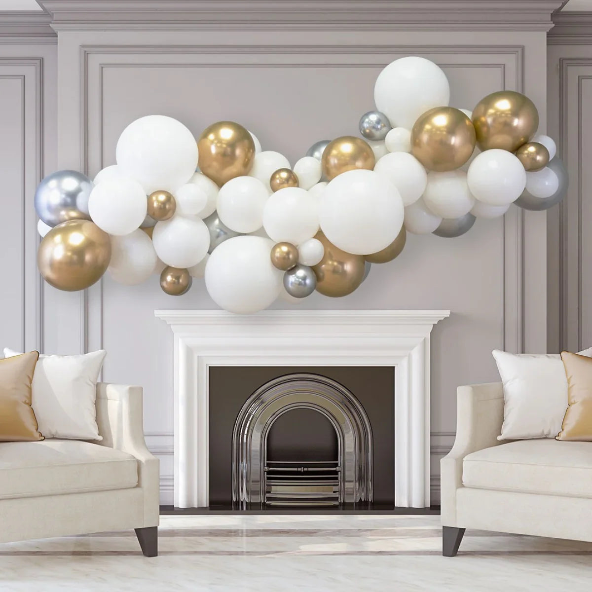 Metallic balloon garland in gold, silver, and white above white fireplace in elegant living room