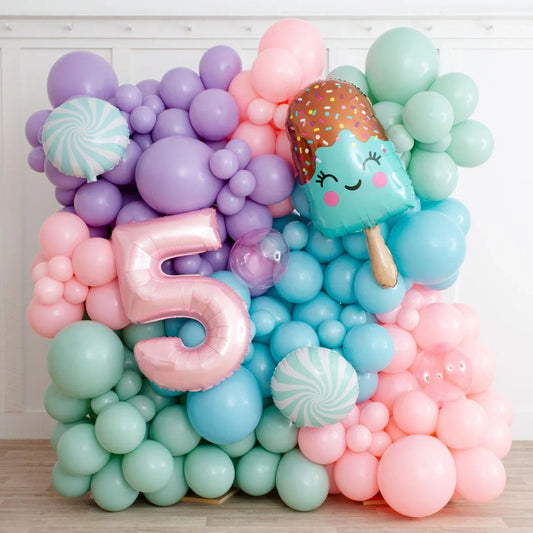 Colorful balloon wall with pastel mint, pink, purple, and blue balloons, featuring a pink number 5 and an ice cream balloon