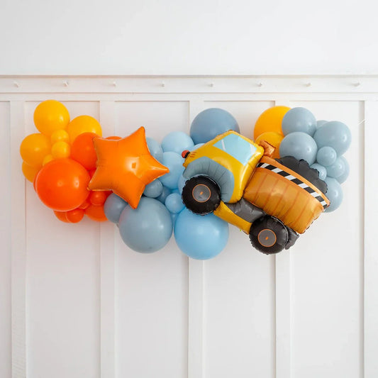 Colorful balloon garland with orange, yellow, and blue balloons, featuring a dump truck and star-shaped balloons