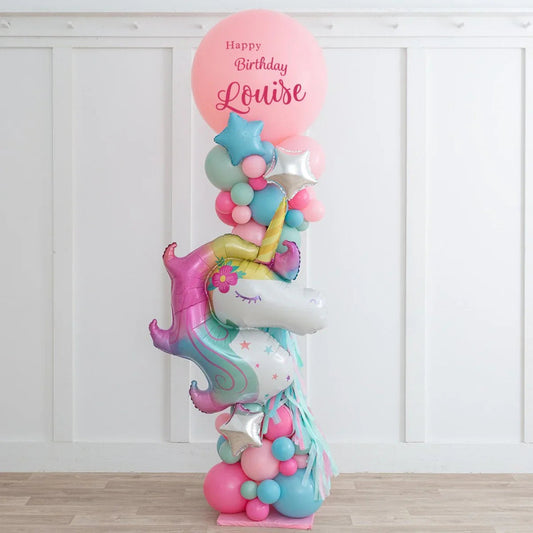 Colorful unicorn balloon sculpture with pastel balloons and "Happy Birthday Louise" pink balloon