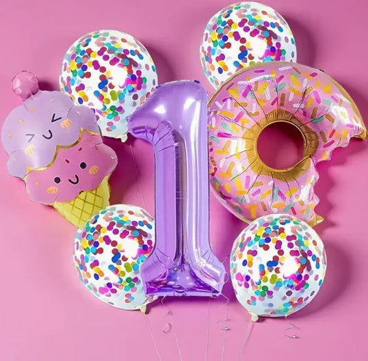 Colorful birthday balloons including purple number 1, pink donut with sprinkles, ice cream cone, and confetti balloons on pink background