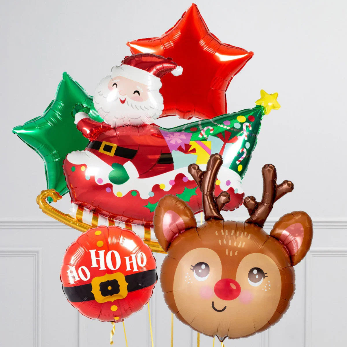 Christmas themed balloons including Santa on sleigh, reindeer face, red and green star balloons, and Ho Ho Ho text