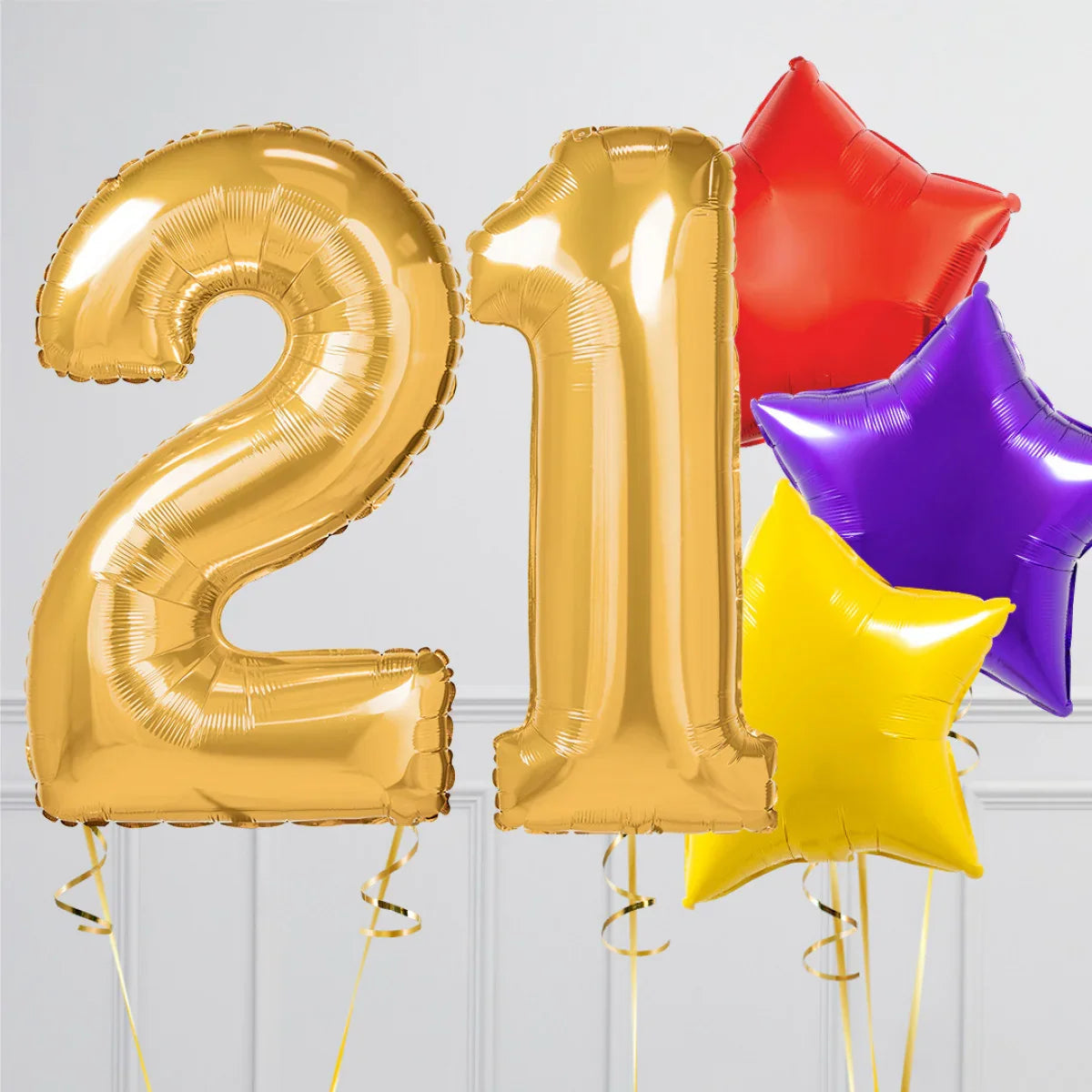 Gold foil balloons shaped as number 21 with red, purple, and yellow star-shaped balloons