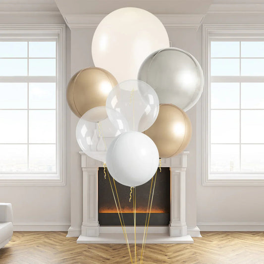 Elegant pearl and metallic balloons in gold, silver, and white colors displayed in a modern living room with fireplace