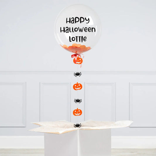 Personalized clear Halloween balloon with orange confetti, spiders, pumpkins, and 'Happy Halloween Lottie' text