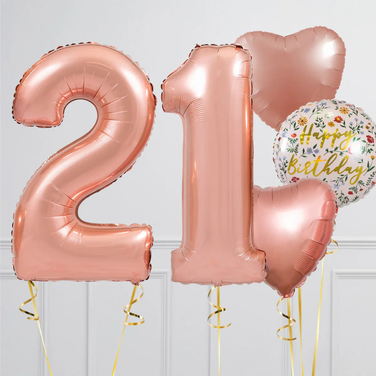 Rose gold foil balloons shaped as number 21 with heart and floral Happy Birthday balloons