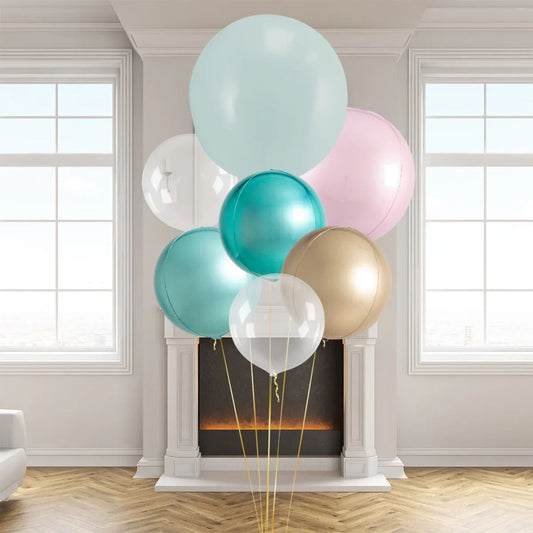 Cluster of pastel and metallic helium balloons in front of a modern fireplace in a bright room