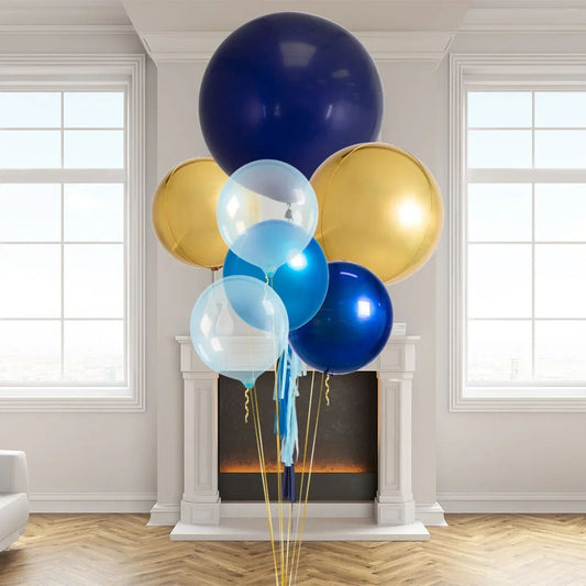 Cluster of sapphire blue, gold, and transparent balloons in a bright living room with fireplace