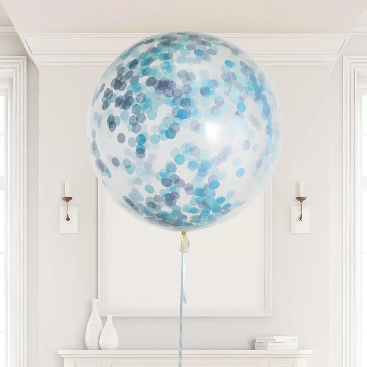 Large transparent helium balloon with blue and gray confetti in elegant white room