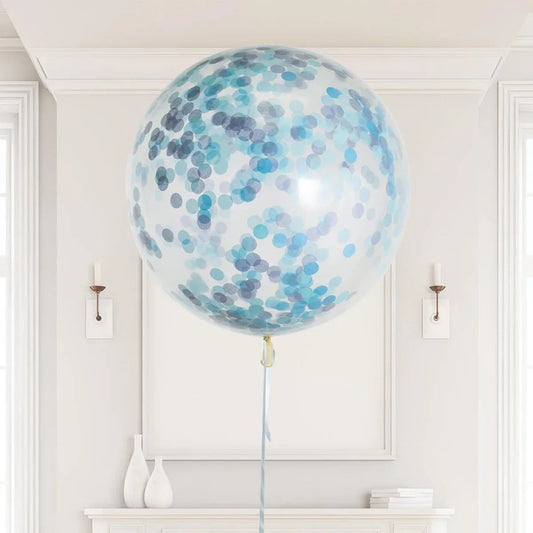 Large transparent helium balloon with blue and gray confetti in elegant white room