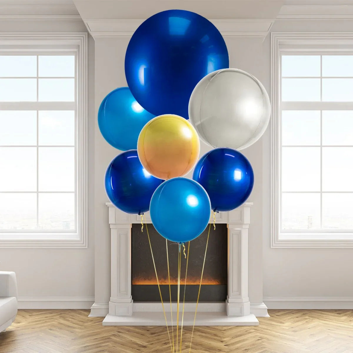 Cluster of shiny blue, gold, and silver helium balloons in a modern room with white fireplace and large windows