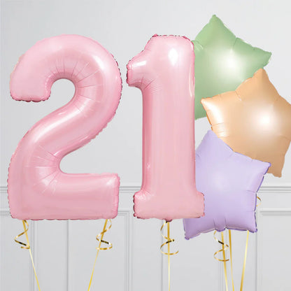 Pink number 21 balloons with green, orange, and purple star-shaped balloons on gray background