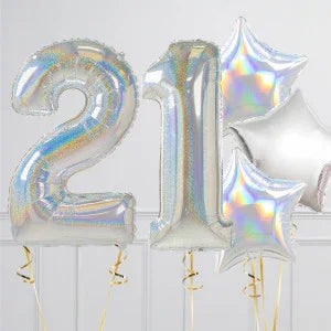 Holographic silver foil balloons shaped as number 21 and stars on white background
