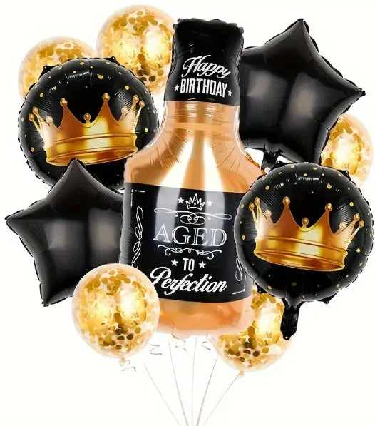 Birthday balloon bouquet featuring a whiskey bottle shape with text aged to perfection, black star and crown balloons, and gold confetti balloons